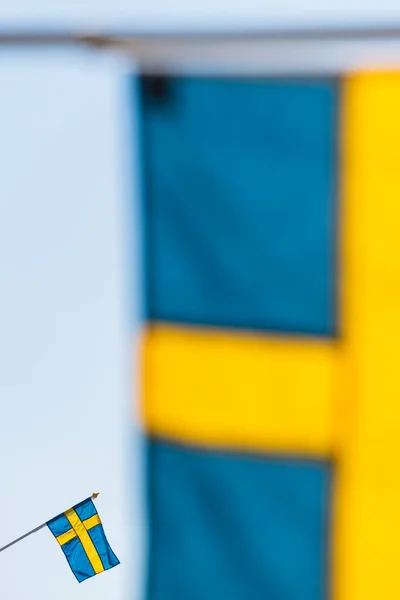 Swedish flag behind another flag