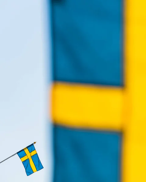 Swedish flag behind another flag