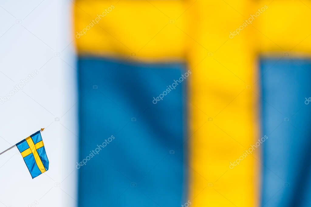 Swedish flag behind another flag