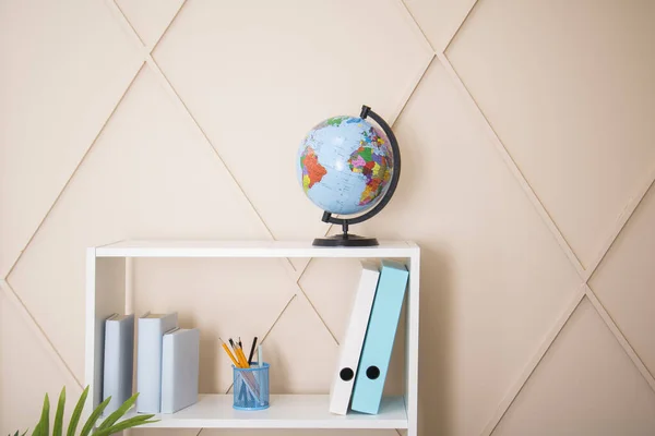 Office interior, globe and plastic file folders