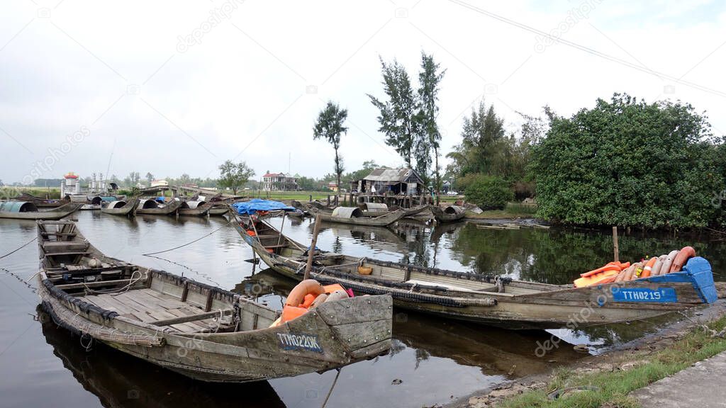 Fishing boats docked by the river