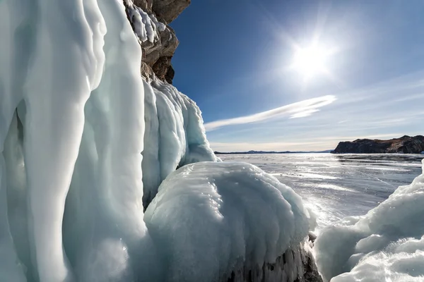 Big icicles on the rock against sunny sky Stock Picture