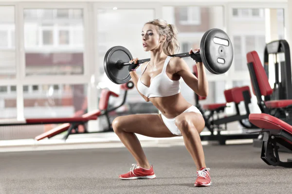 Woman doing exercise with barbell — Stock Photo, Image