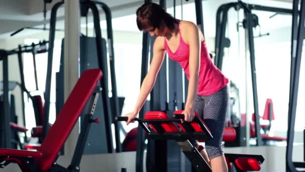 Jeune femme faisant de l'exercice pour le dos à la salle de gym — Video