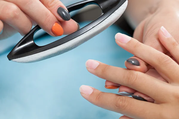 Beautician polishing female nails — Stock Photo, Image