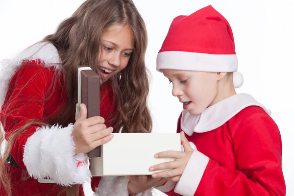 Christmas boy and girl opening the gifts. — Stock Photo, Image