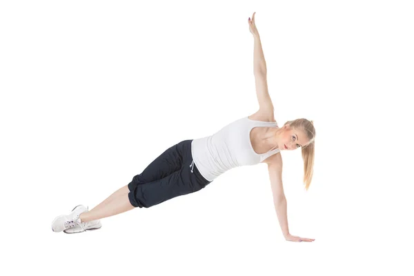 Mujer deportiva haciendo ejercicio. Aislado sobre fondo blanco — Foto de Stock