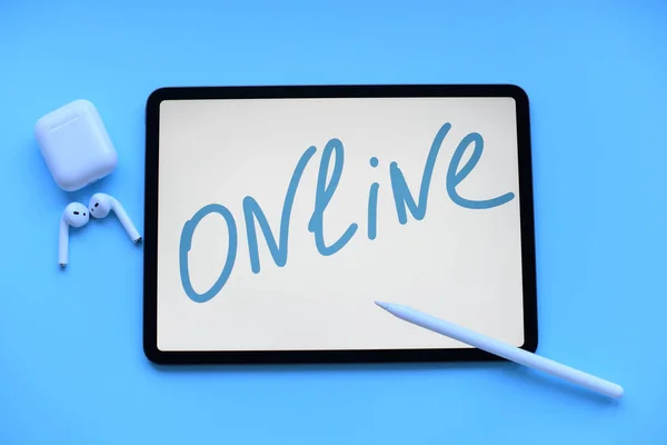 Tablet med inskription online med penna och luftkapslar på blå bakgrund — Stockfoto