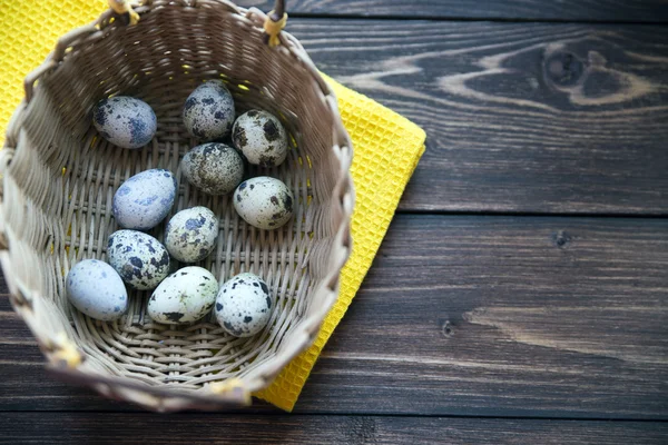 Easter quail eggs in the basket on rustic wooden background. Selective soft focus — Stock Photo, Image