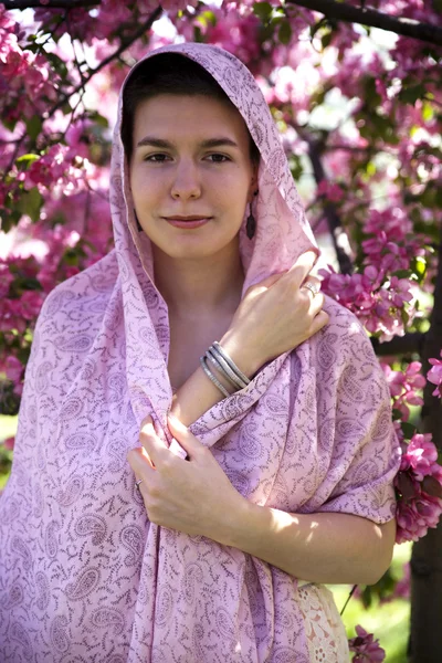 Beautiful teen girl wearing a pink scarf — Stockfoto