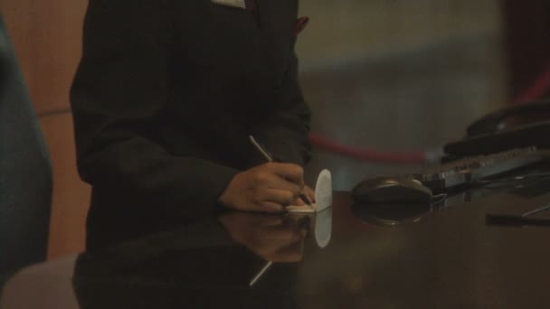 Businessman checking in at reception — Stock Video