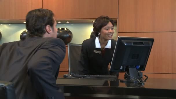 Businessman checking in at reception — Stock Video