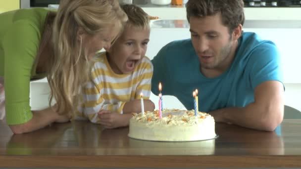 Boy blowing out candles — Stock Video