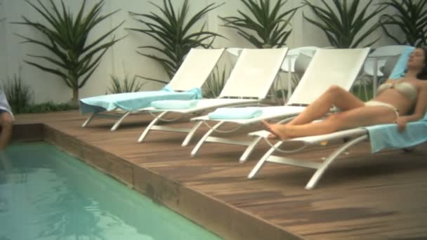 Woman reclining on a lounge chair — Stock Video