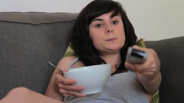 Weibchen auf dem Sofa essen — Stockvideo