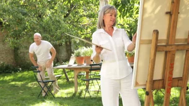 Pintura en pareja en el jardín — Vídeos de Stock