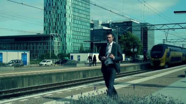 Businessman at train station — Stock Video