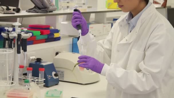 Female scientist looks at screen with stem cells — Stock Video