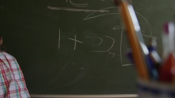 Girl writing on blackboard — Stock Video