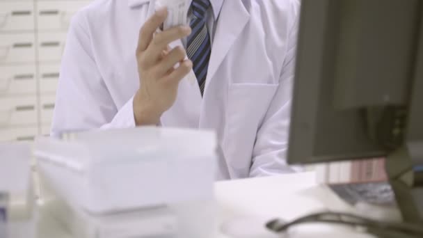 Фармацевт тримає пляшку таблеток — стокове відео