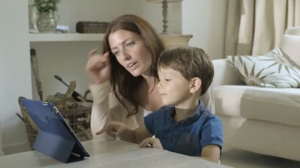 Мати і син дивиться цифровий планшет — стокове відео