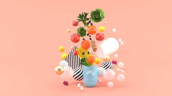 ピンクの背景にカラフルなボールの中に食べ物がカプセルの外に浮かんでいます — ストック写真