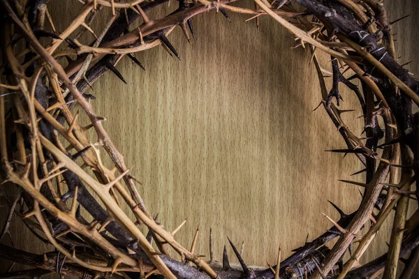 Crown of thorns on wood desk. Christian concept