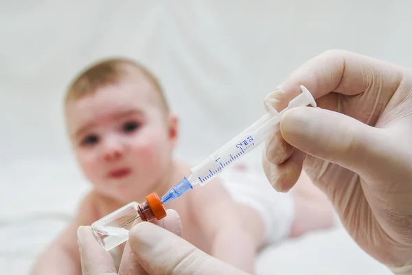 Doctor holds syringe to vaccinate  baby with injection — Stock Photo, Image