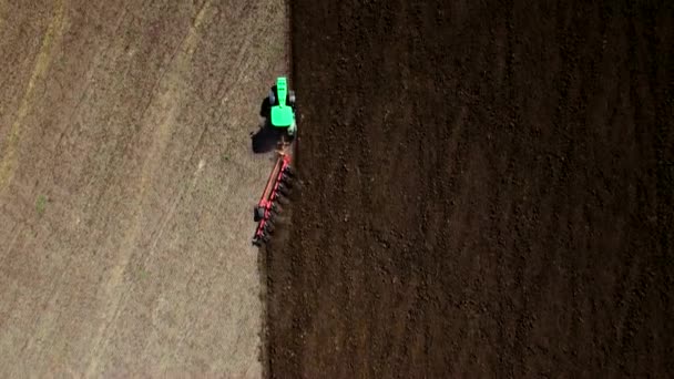 Aerial top view of tractor plowing the soil — Stock Video