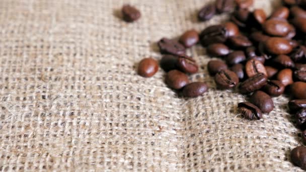 Coffee beans on the sackcloth. Dolly shot. — Stock Video