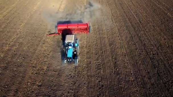 Aerial view of tractor sowing wheat — Stock Video