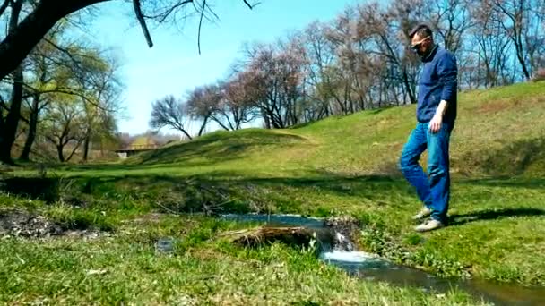 Jeune randonneur recueille de l'eau dans une bouteille — Video