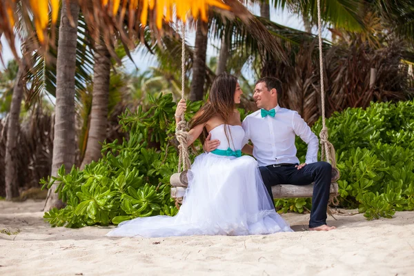 Young loving couple on the swing — Stock Photo, Image