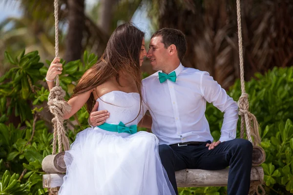 Young loving couple on the swing — Stock Photo, Image