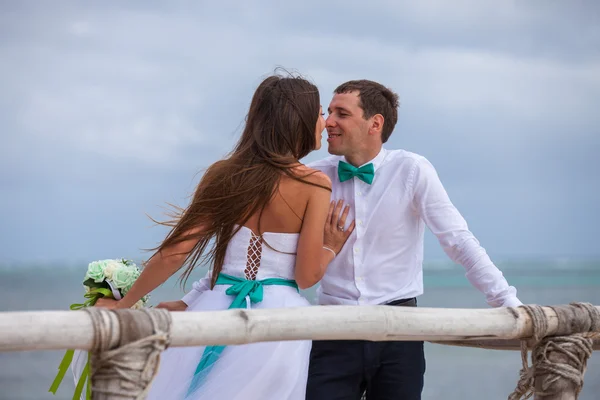 Bride and groom together on a wharf — Stock Photo, Image