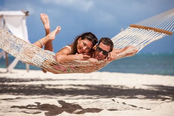 Romantic Couple Relaxing In Beach Hammock Royalty Free Stock Images