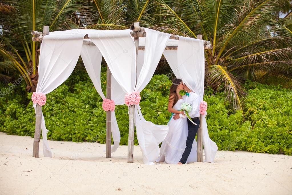 Young loving couple wedding in gazebo.