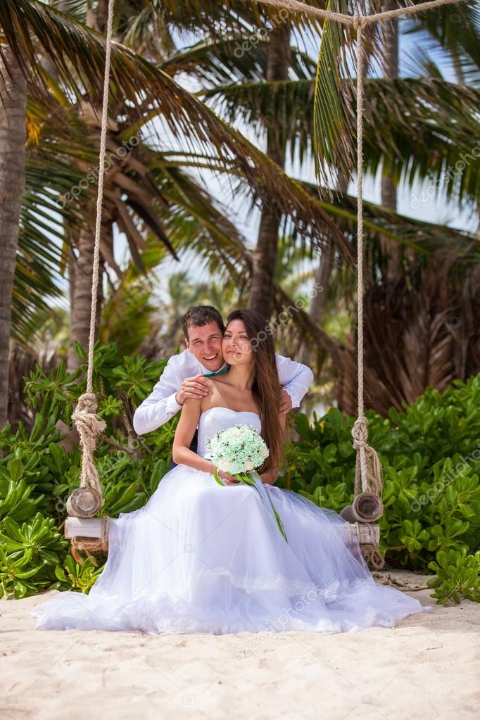 Young loving couple on the swing