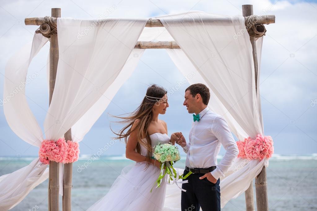 Young loving couple wedding in gazebo.