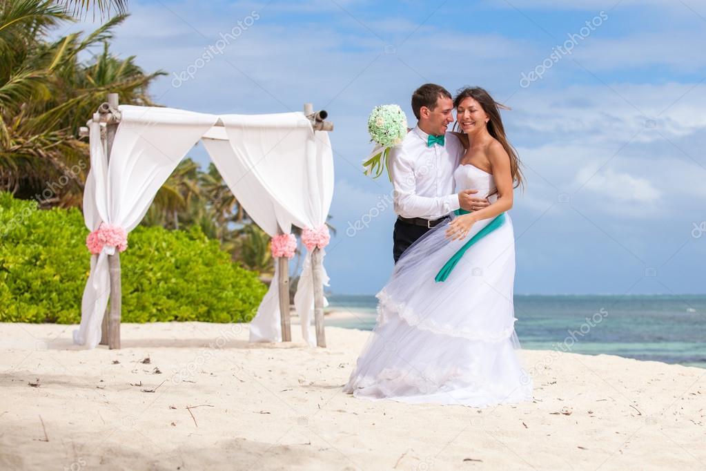 Young loving couple wedding in gazebo.