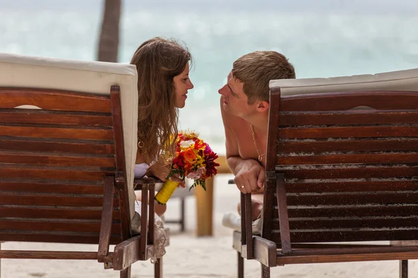 Marido y mujer relajándose en tumbonas en la playa —  Fotos de Stock