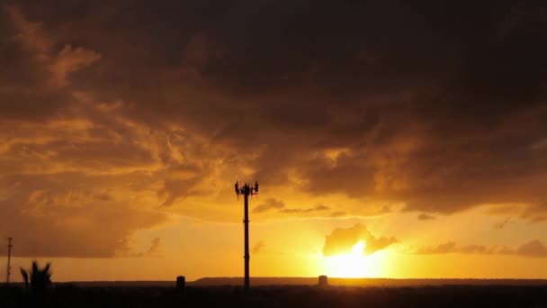 Communication tower with a sunset in background — Stock Video