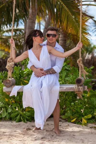 Young loving couple on the swing — Stock Photo, Image