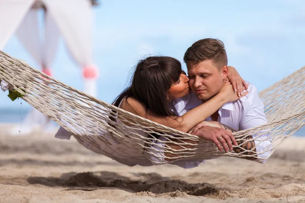 Casal romântico relaxante na rede de praia — Fotografia de Stock