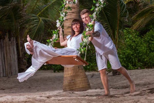 Young loving couple on the swing — Stock Photo, Image