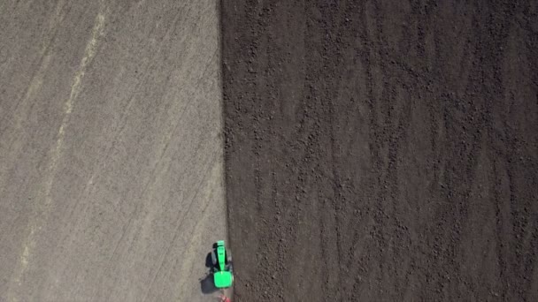 Aerial: Tractor plowing the soil. Top view. — Stock Video