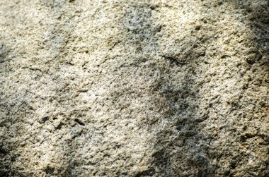 Details of stone texture, close up shot of rock surface with vignette at cover and bright spot.