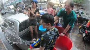 BANGKOK, THAILAND - 13 Nisan 2019: Tayland 'daki Bangkok şehrinde düzenlenen Songkran Festivali' nde arabalara su sıçratan bir grup Taylandlı.