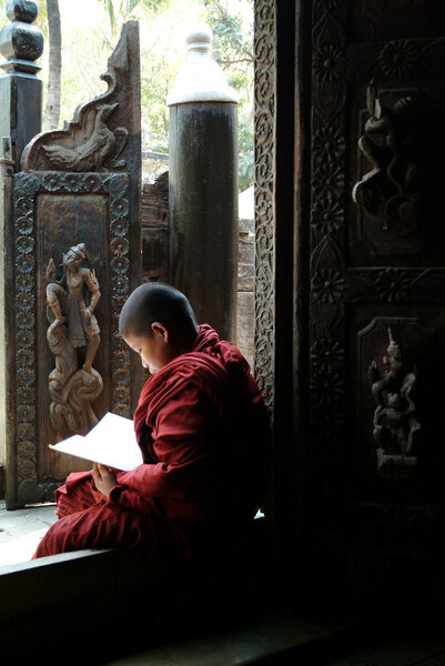 Young monks reading a book at Shwenandaw Monastery in Mandalay,M