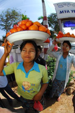 Kadın taşıma portakal için kafasındaki satmak.